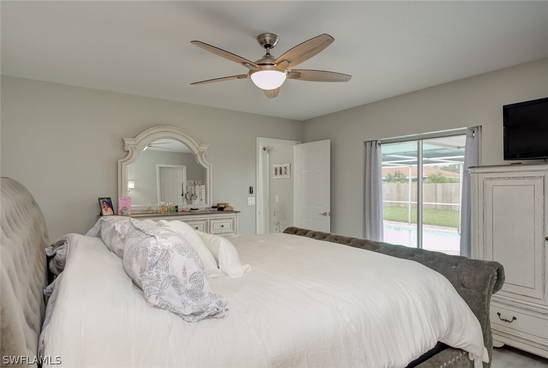 17388 Ingram Road Fort Myers, FL 33967 - Photo 9 of 18 a bedroom with a large bed and a flat screen tv
