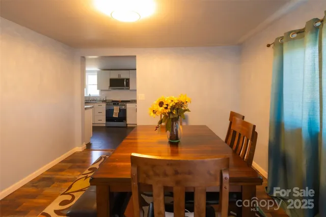 a dining room with furniture and wooden floor