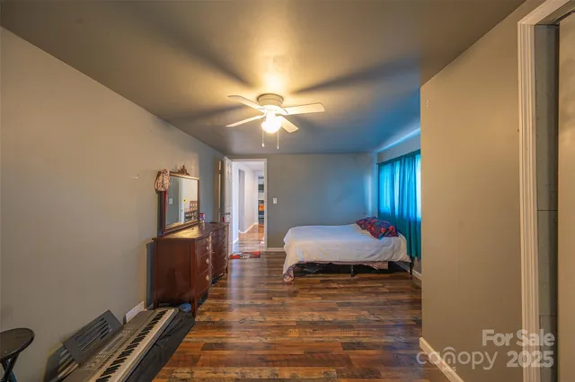 a spacious bedroom with a bed and a chandelier