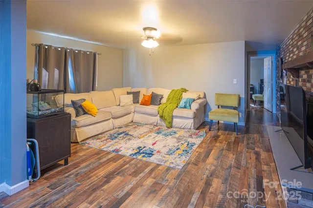 a living room with furniture fireplace and flat screen tv