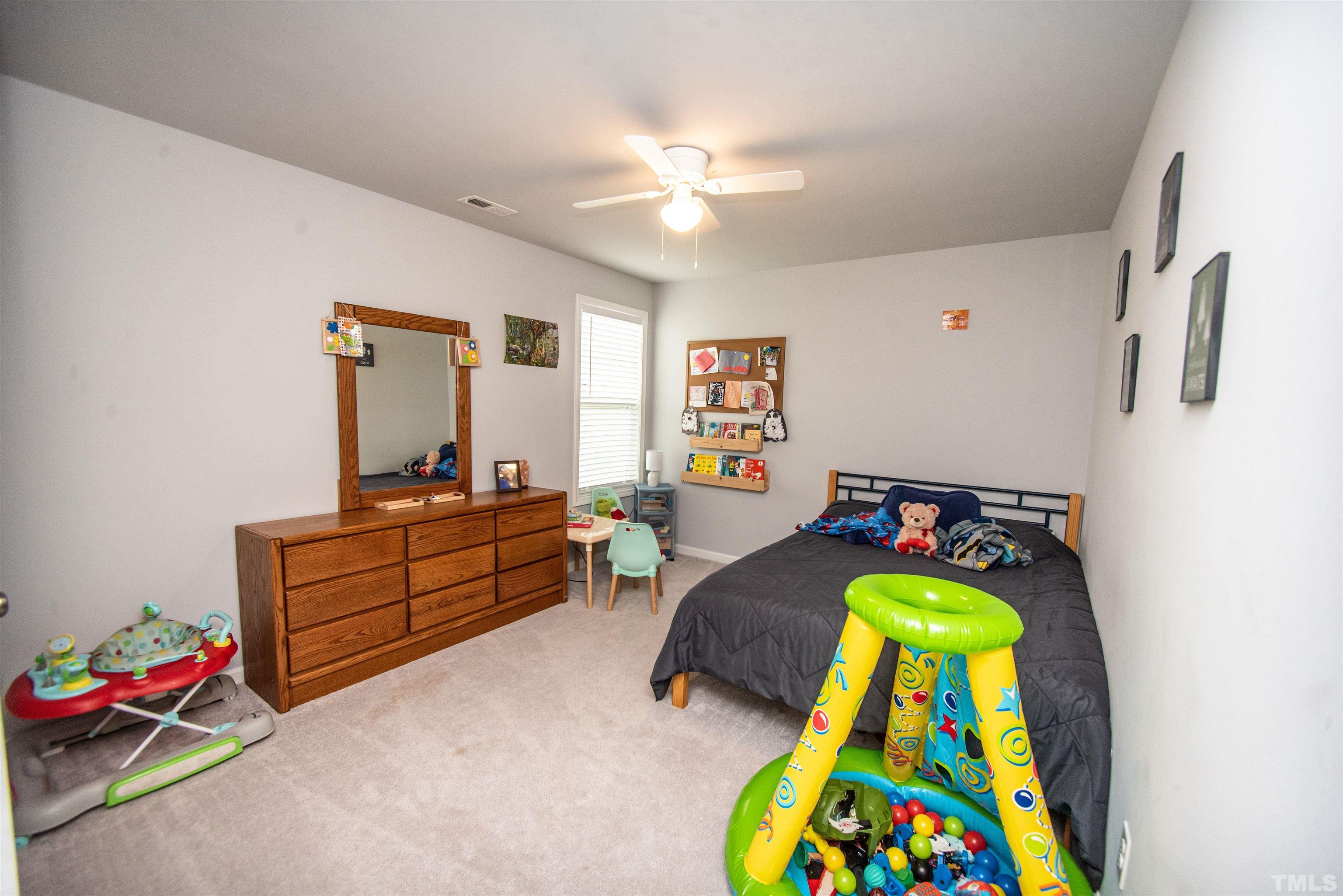 113 Cornfield Lane Benson, NC 27504 - Photo 7 of 13 a bed room with furniture and a table