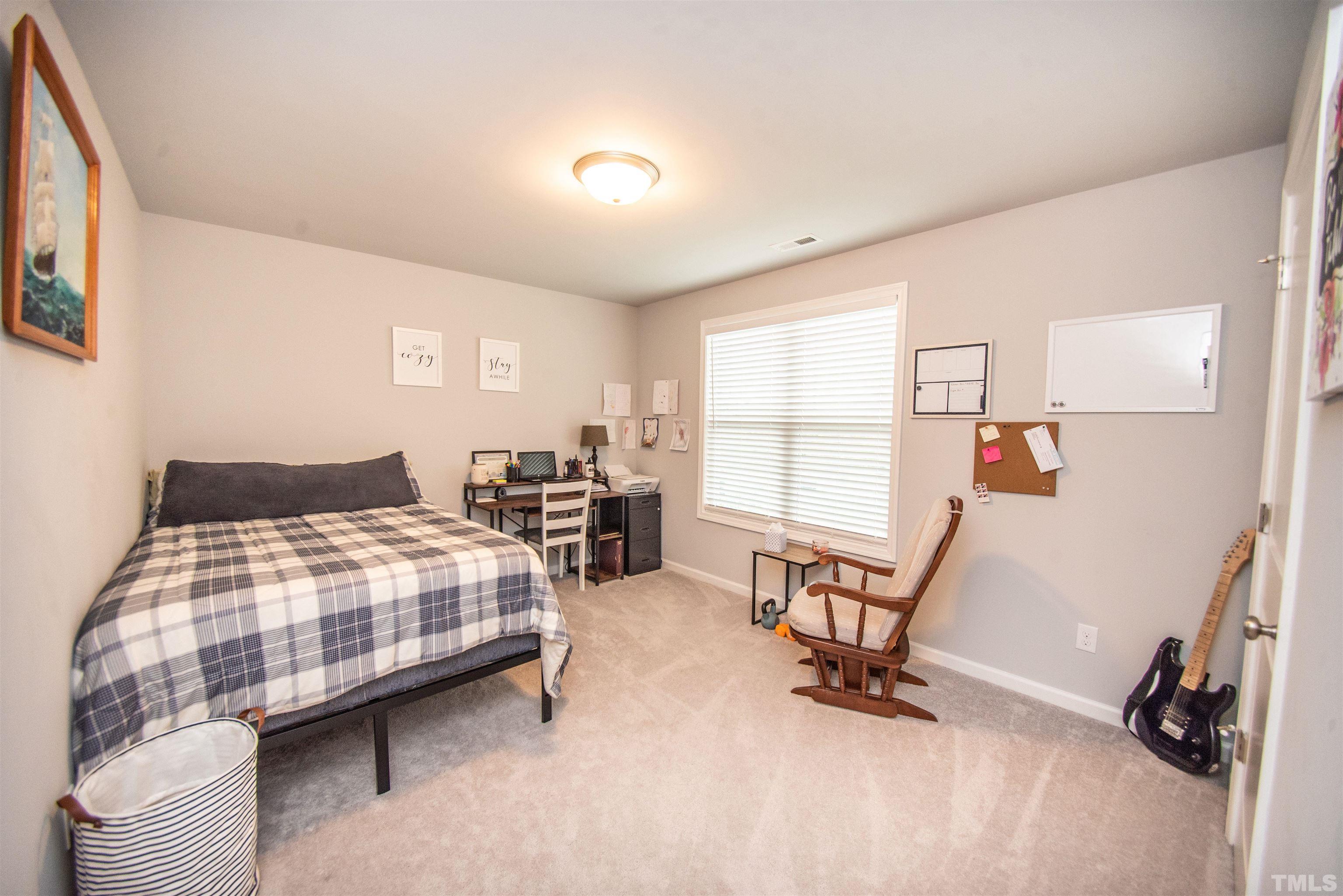 113 Cornfield Lane Benson, NC 27504 - Photo 9 of 13 a bedroom with bed and a large window