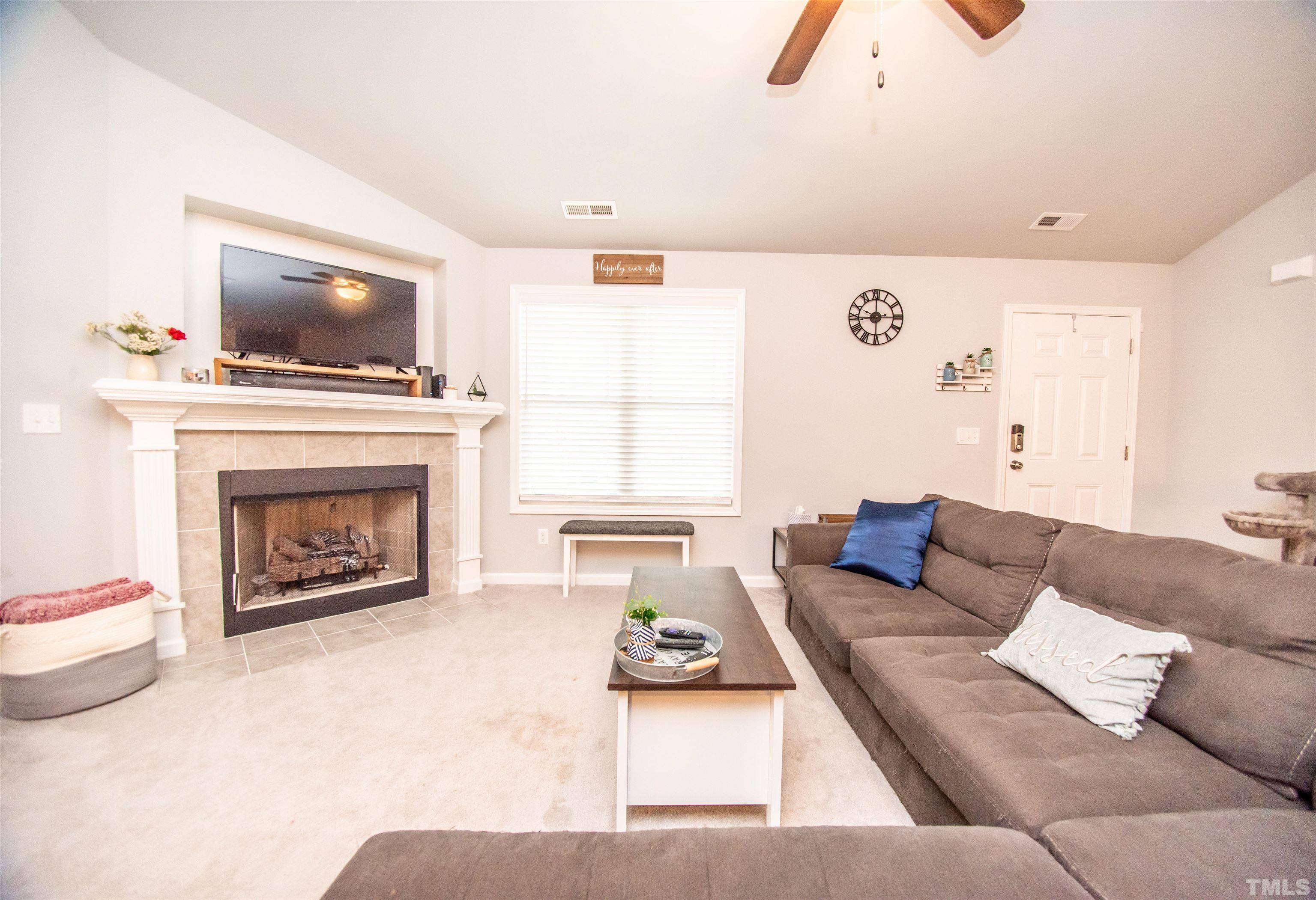 113 Cornfield Lane Benson, NC 27504 - Photo 10 of 13 a living room with furniture and a fireplace