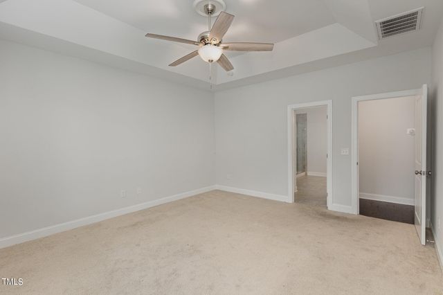 an empty room with window and a ceiling fan