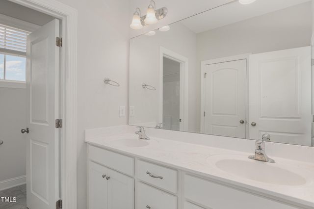 a view of a hallway with closet and bathroom