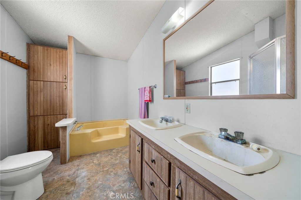 23900 Fellows Way Perris, CA 92570 - Photo 19 of 63 a bathroom with a sink toilet and shower