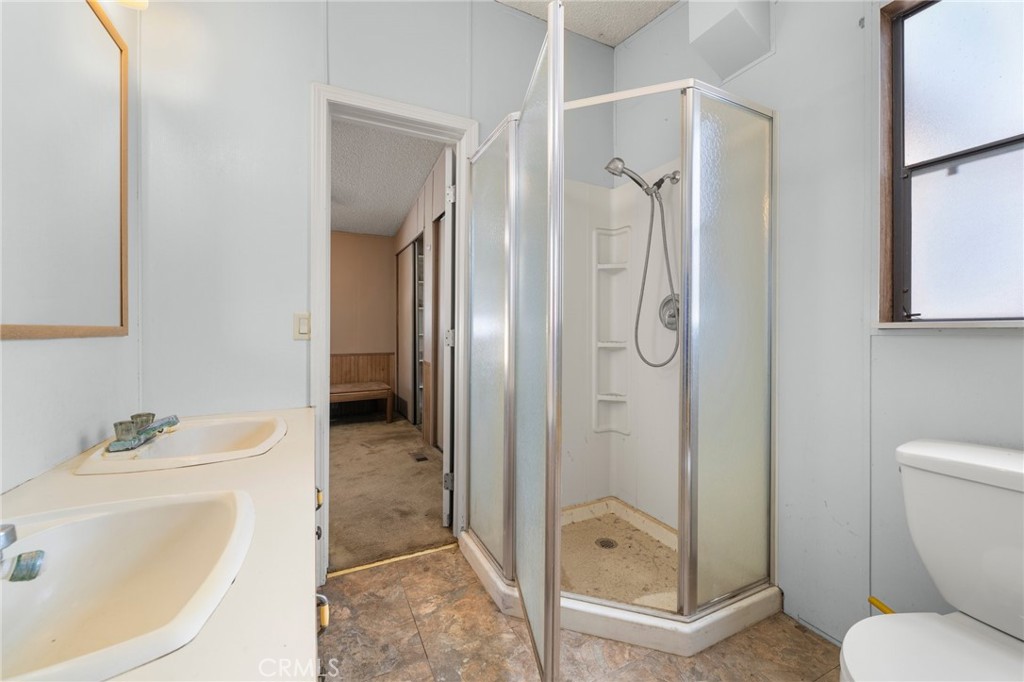 23900 Fellows Way Perris, CA 92570 - Photo 20 of 63 a bathroom with a granite countertop sink toilet and shower