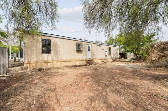 a view of a park with bench and trees