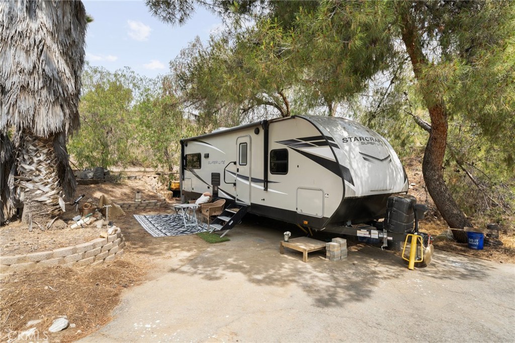 23900 Fellows Way Perris, CA 92570 - Photo 42 of 63 a white house covered with tall trees