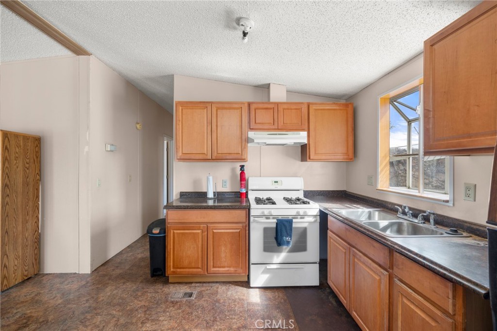 23900 Fellows Way Perris, CA 92570 - Photo 9 of 63 a kitchen with stainless steel appliances granite countertop a sink stove and refrigerator