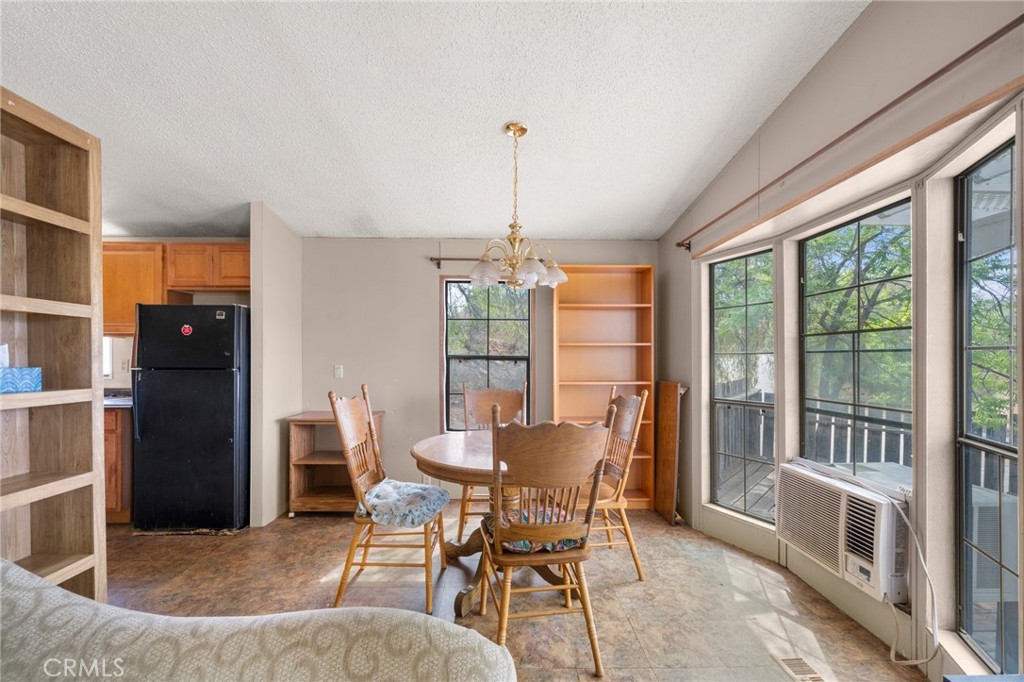 23900 Fellows Way Perris, CA 92570 - Photo 10 of 63 a dining room with furniture large windows and a chandelier