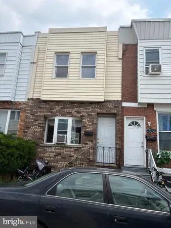 a front view of a house with parking space