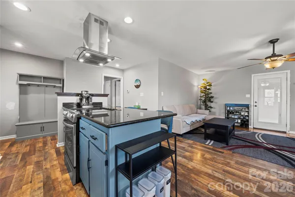 a kitchen with stainless steel appliances granite countertop a sink and a stove