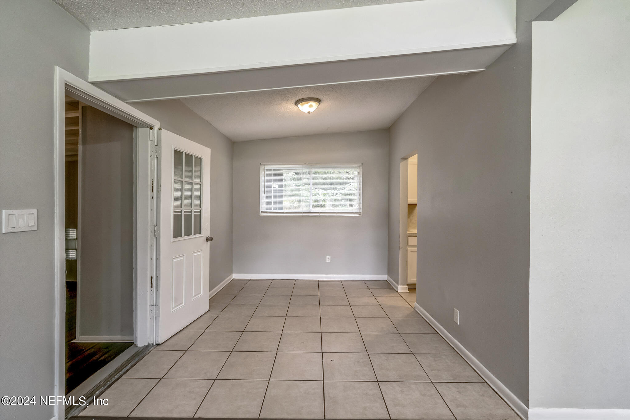 6974 Rollo Road Jacksonville, FL 32205 - Photo 5 of 16 a view of an empty room with window