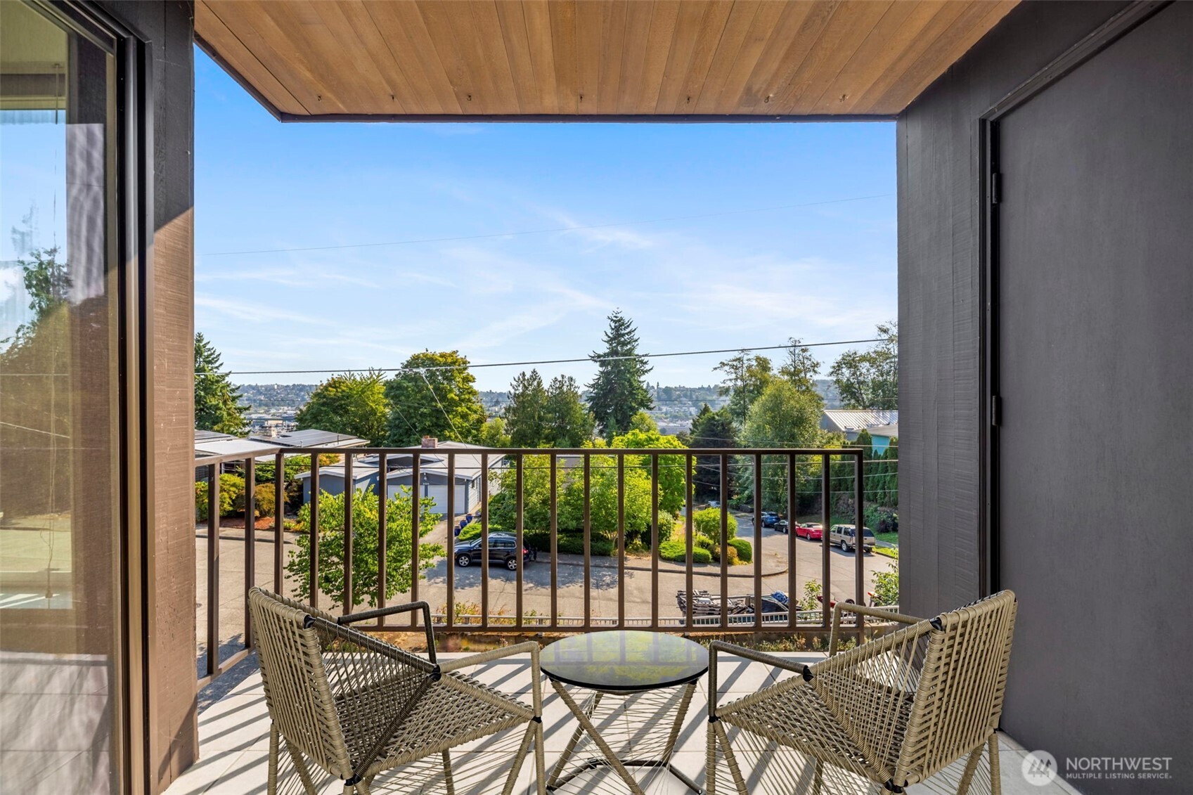 3601 24th Avenue West, Unit 207 Seattle, WA 98199 - Photo 12 of 24 a view of a balcony with chairs and a potted plant