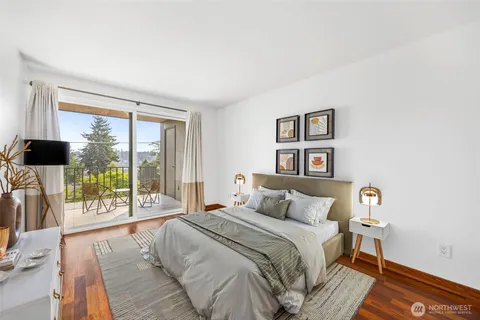 a bedroom with a large bed and a large window