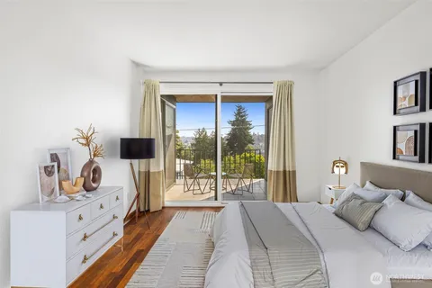 a bedroom with a bed and a large window