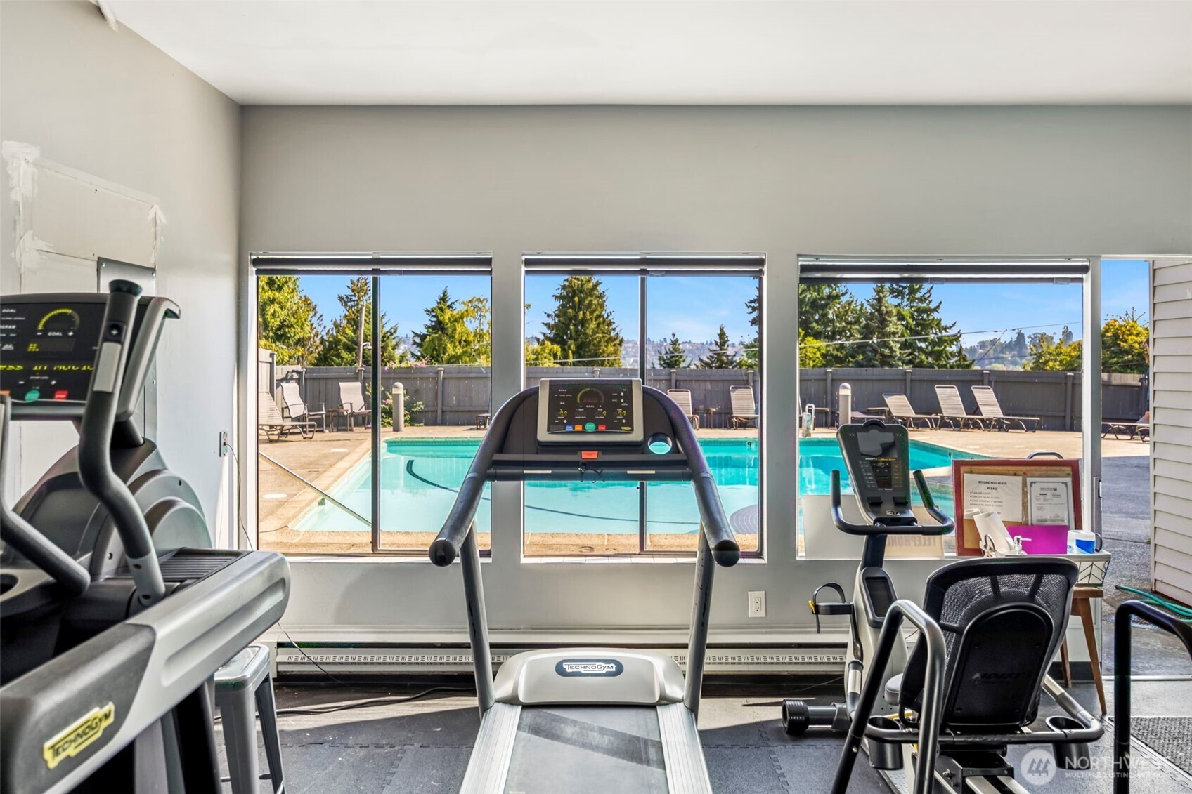 3601 24th Avenue West, Unit 207 Seattle, WA 98199 - Photo 19 of 24 a living room with furniture a floor to ceiling window and a flat screen tv