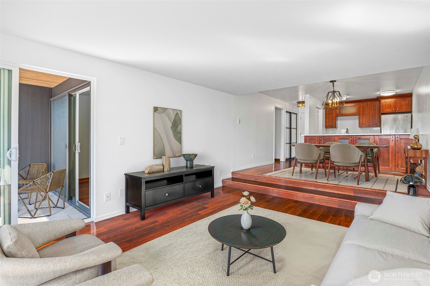 3601 24th Avenue West, Unit 207 Seattle, WA 98199 - Photo 2 of 24 a living room with furniture a rug and a chandelier