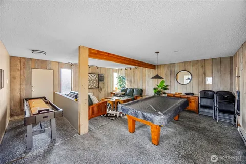 a living room with furniture a rug and white walls
