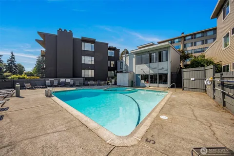 a view of a house with swimming pool and sitting area
