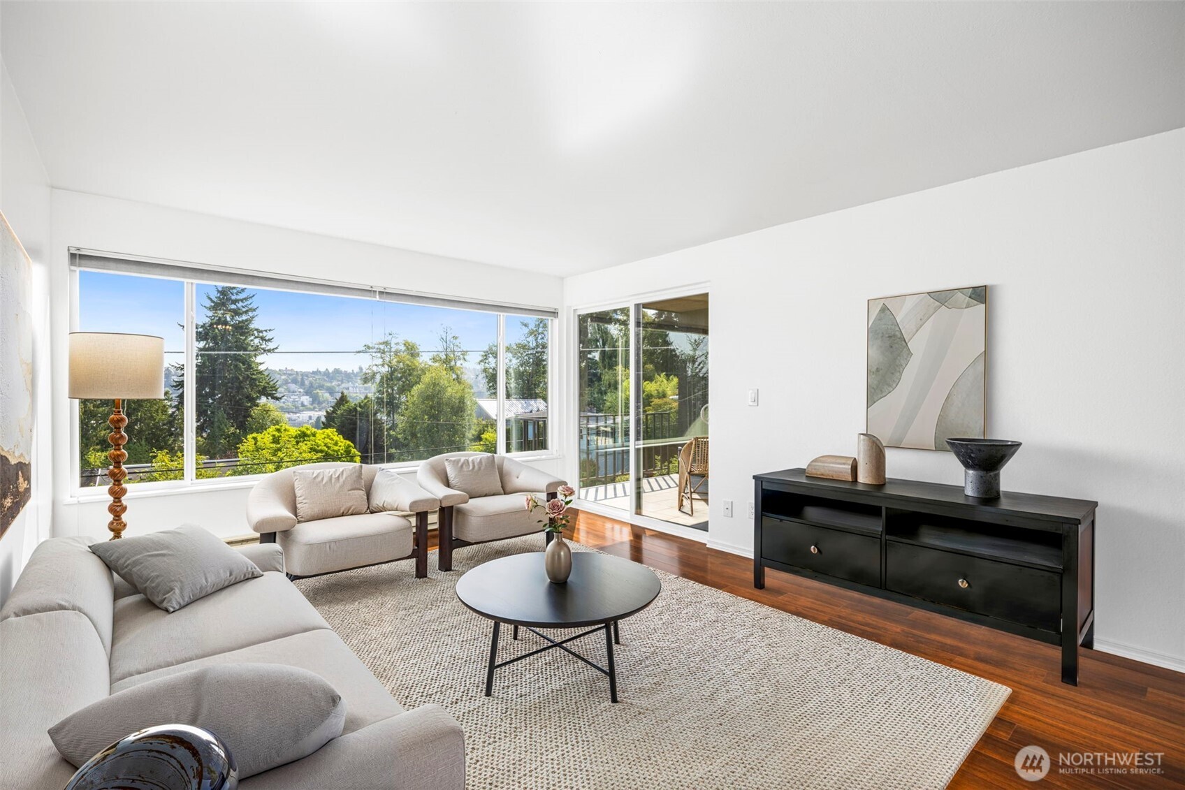 3601 24th Avenue West, Unit 207 Seattle, WA 98199 - Photo 3 of 24 a living room with furniture a rug and a floor to ceiling window