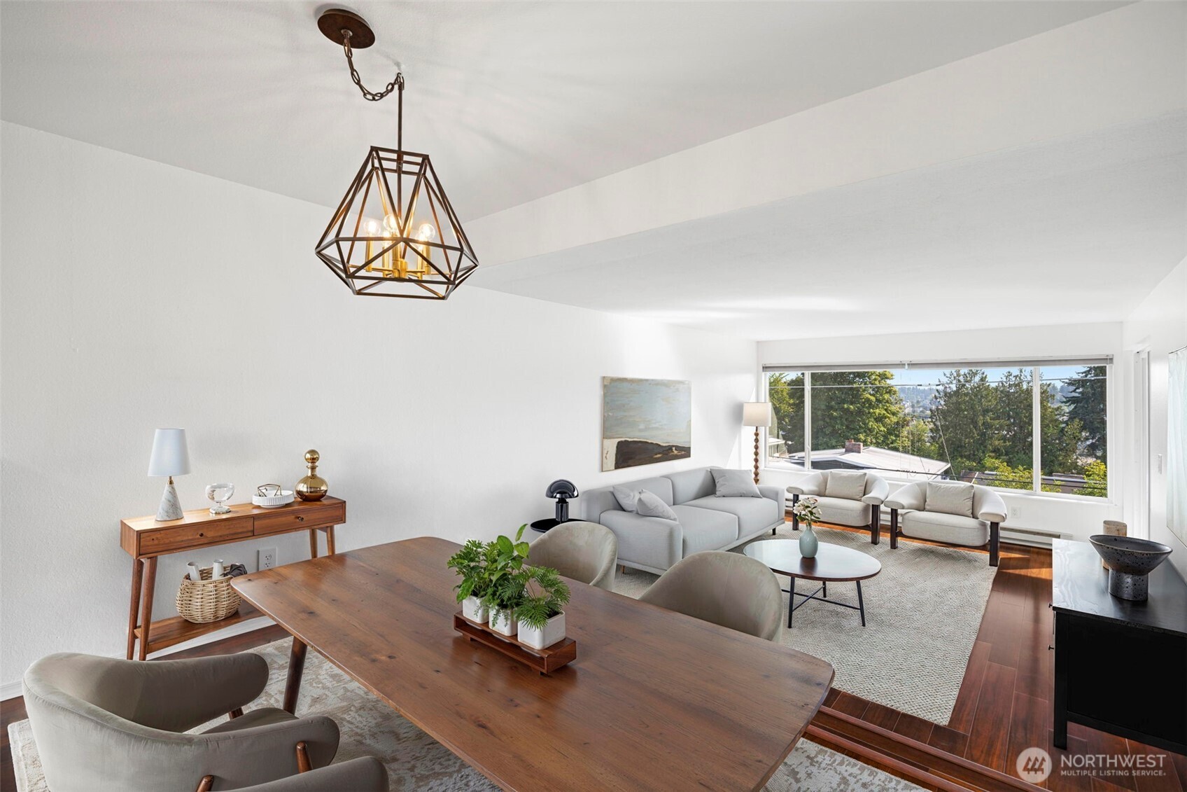 3601 24th Avenue West, Unit 207 Seattle, WA 98199 - Photo 5 of 24 a living room with furniture and a chandelier