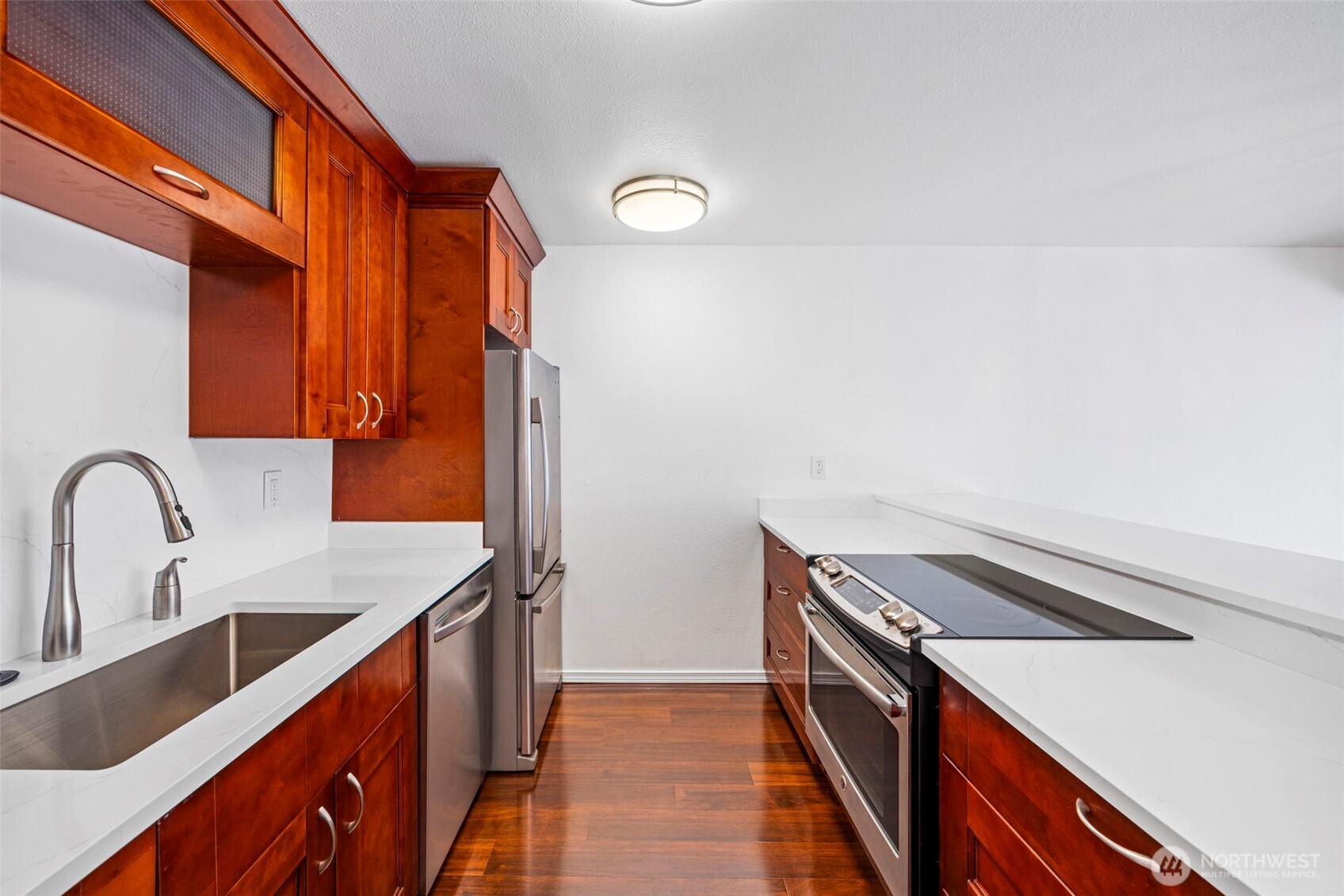 3601 24th Avenue West, Unit 207 Seattle, WA 98199 - Photo 7 of 24 a kitchen with a sink and a stove top oven