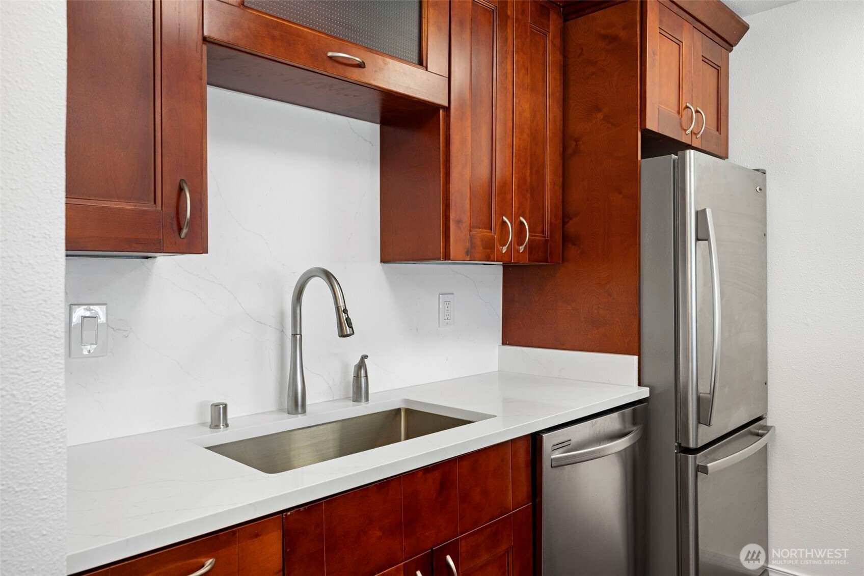 3601 24th Avenue West, Unit 207 Seattle, WA 98199 - Photo 8 of 24 a close view of a sink and a refrigerator in a kitchen
