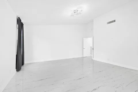 a spacious bathroom with a tub sink and mirror