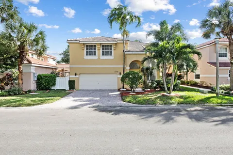 a view of a house with a yard and plants