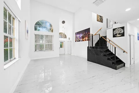 a view of a livingroom with wooden floor and stairs