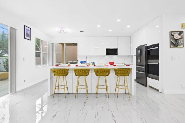 a white toilet sitting next to a bathroom sink