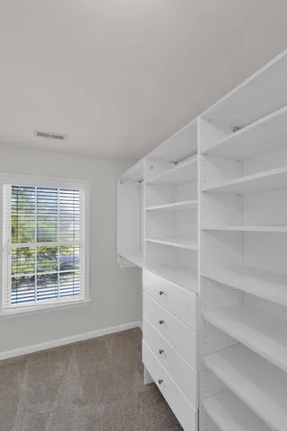 a view of a big house with a big yard and large trees