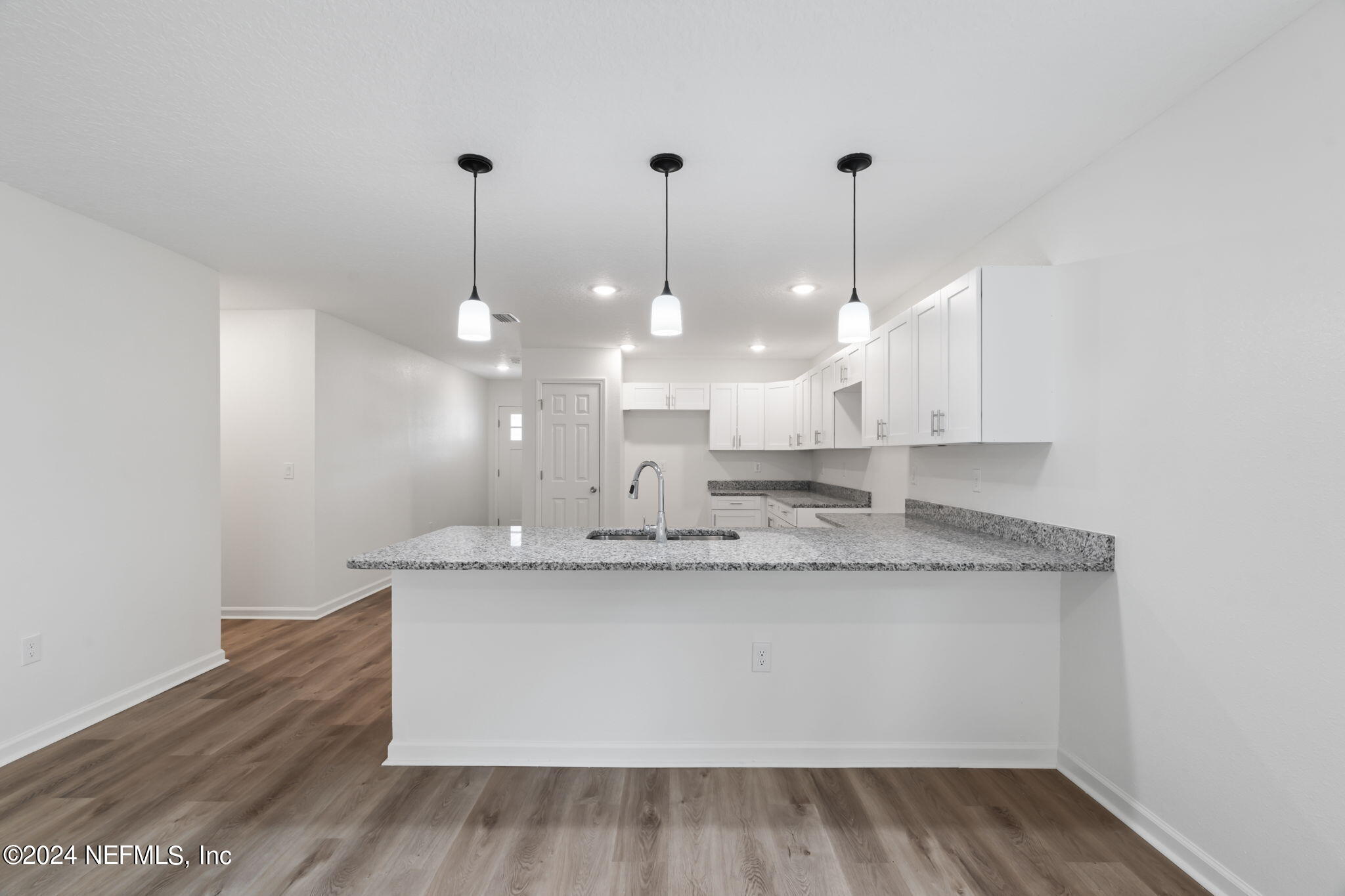 1014 Floyd Street Fleming Island, FL 32003 - Photo 14 of 48 a view of a kitchen with a sink and chandelier