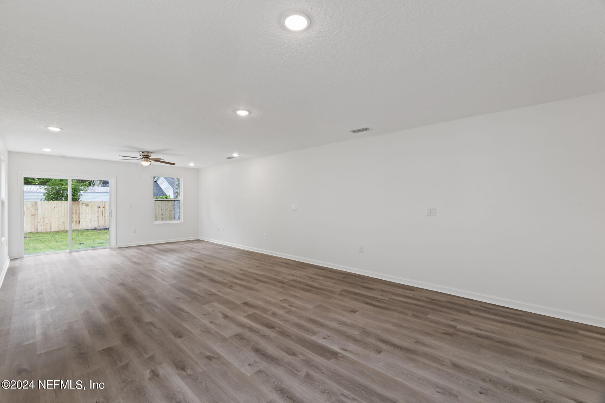 1014 Floyd Street Fleming Island, FL 32003 - Photo 15 of 48 an empty room with wooden floor and windows