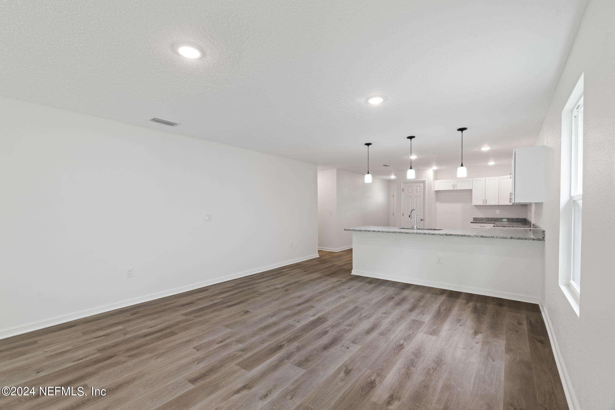 1014 Floyd Street Fleming Island, FL 32003 - Photo 16 of 48 a large room with kitchen island in the center