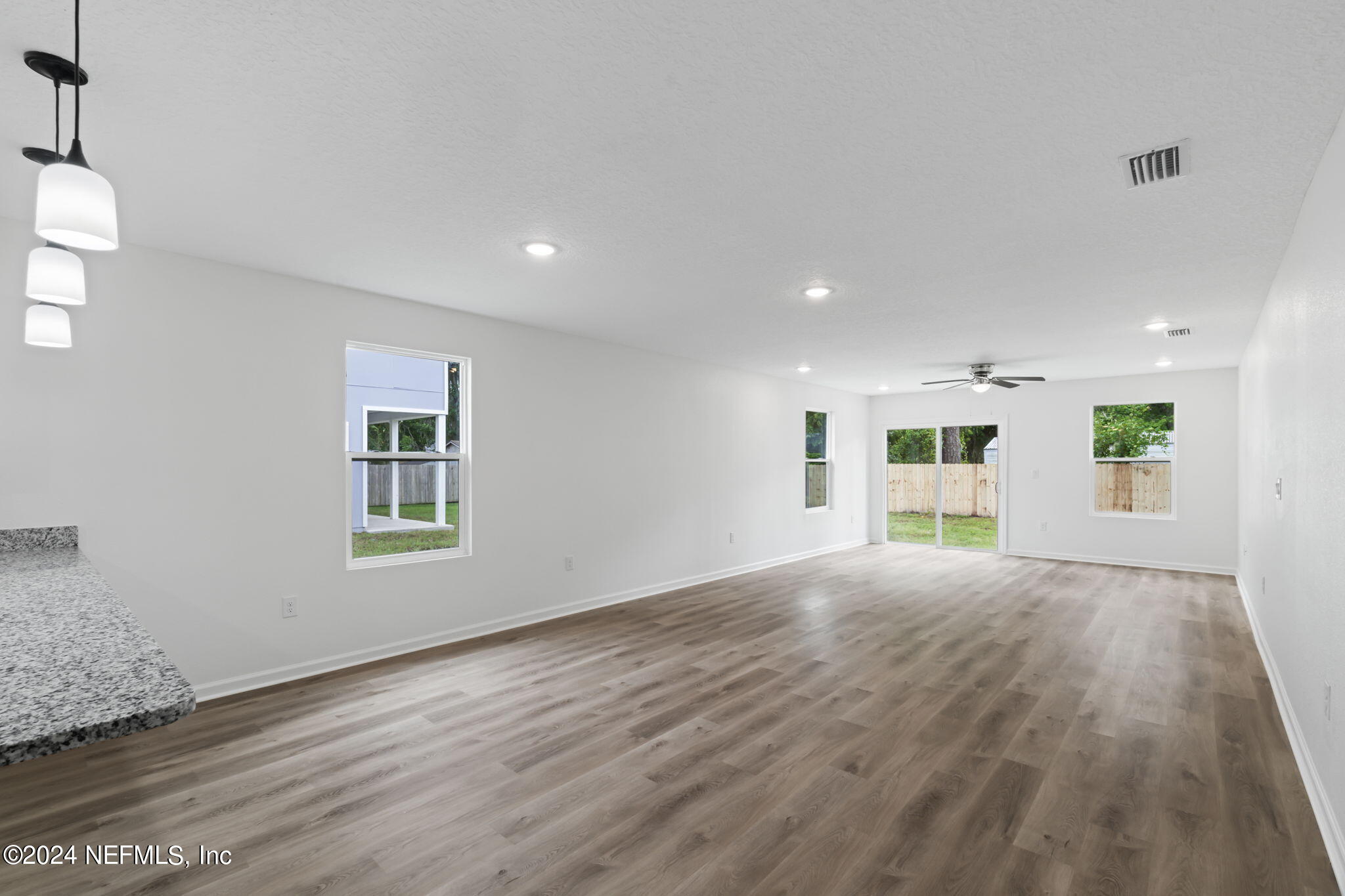1014 Floyd Street Fleming Island, FL 32003 - Photo 17 of 48 a view of an empty room with a window and wooden floor