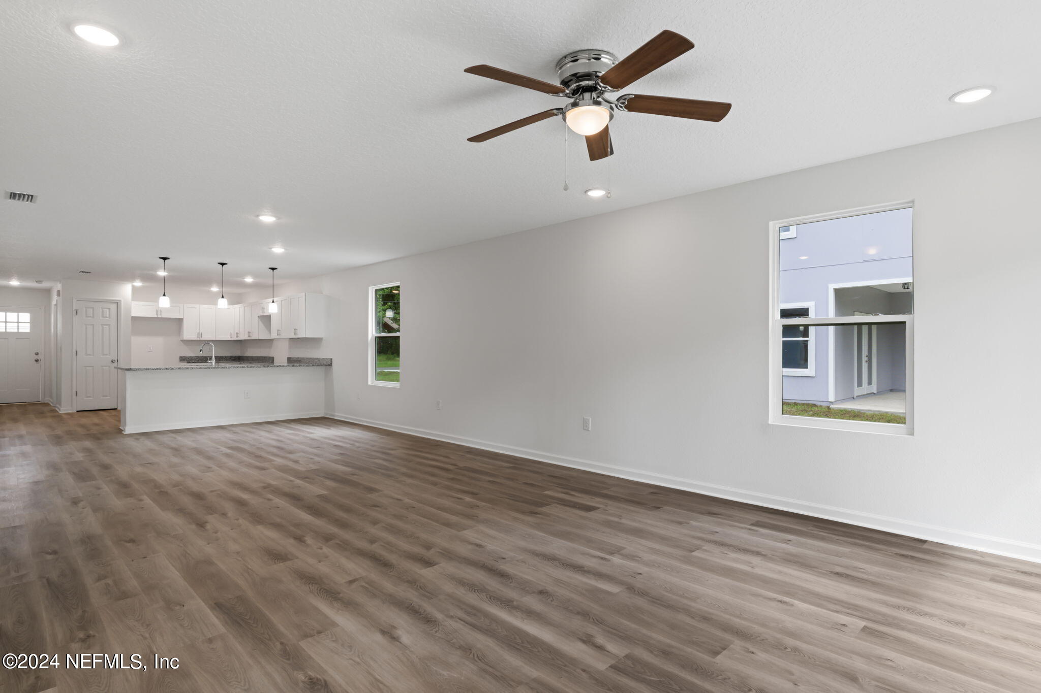 1014 Floyd Street Fleming Island, FL 32003 - Photo 22 of 48 an empty room with wooden floor and windows
