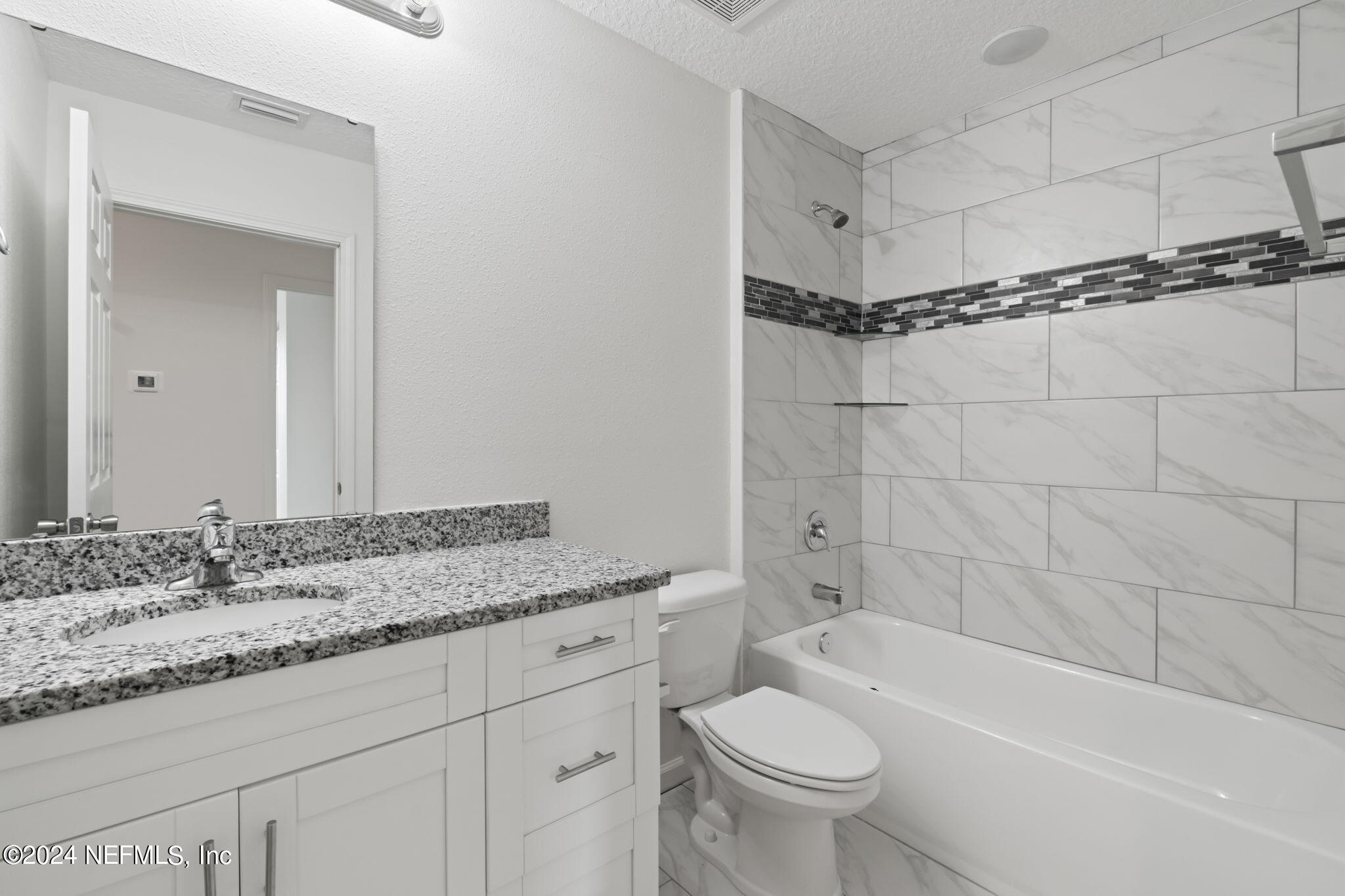 1014 Floyd Street Fleming Island, FL 32003 - Photo 26 of 48 a bathroom with a granite countertop sink toilet and shower