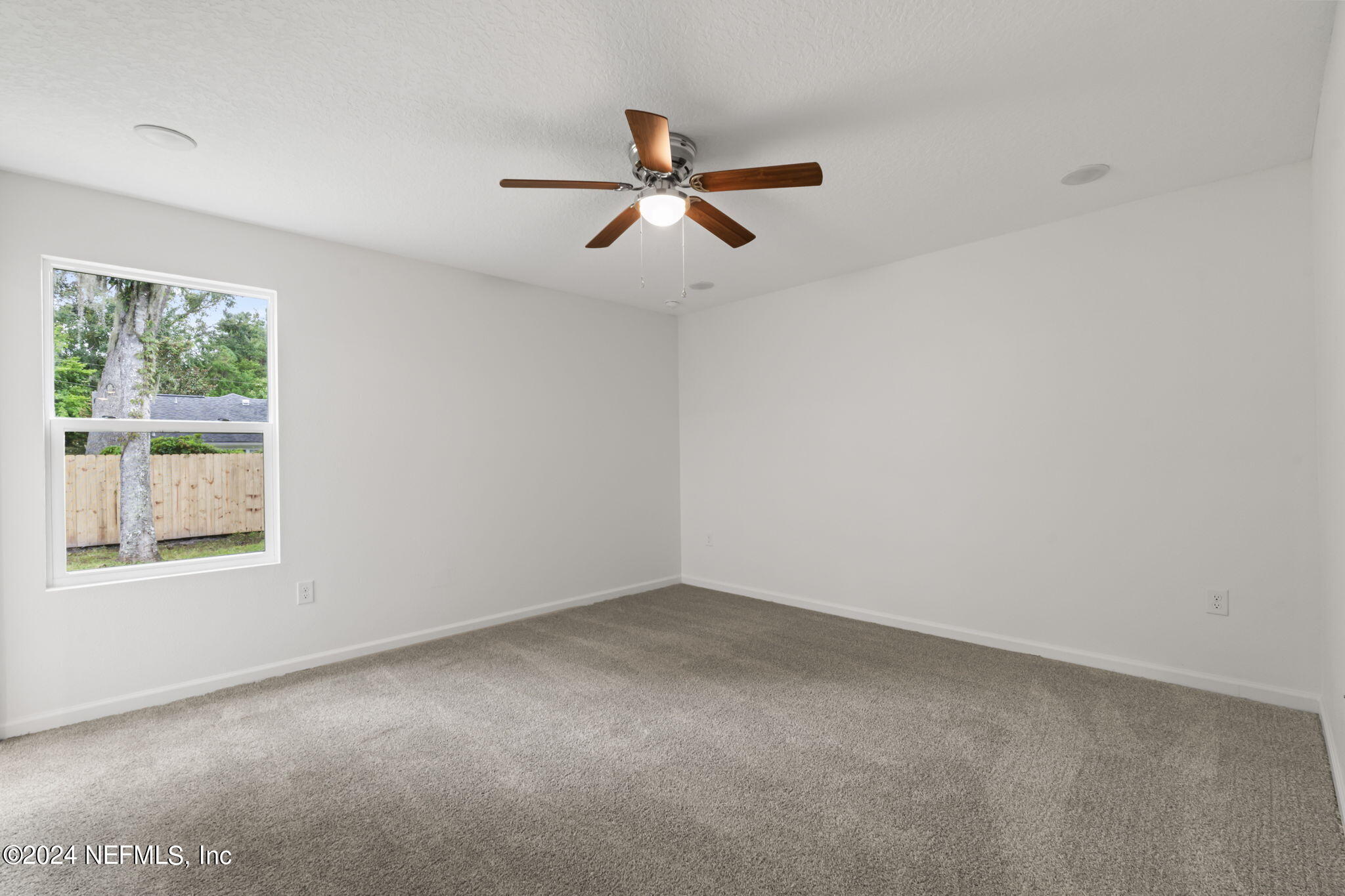 1014 Floyd Street Fleming Island, FL 32003 - Photo 28 of 48 an empty room with windows and fan