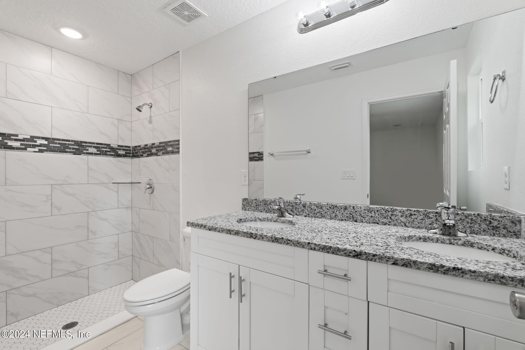 1014 Floyd Street Fleming Island, FL 32003 - Photo 31 of 48 a bathroom with a granite countertop sink toilet and shower