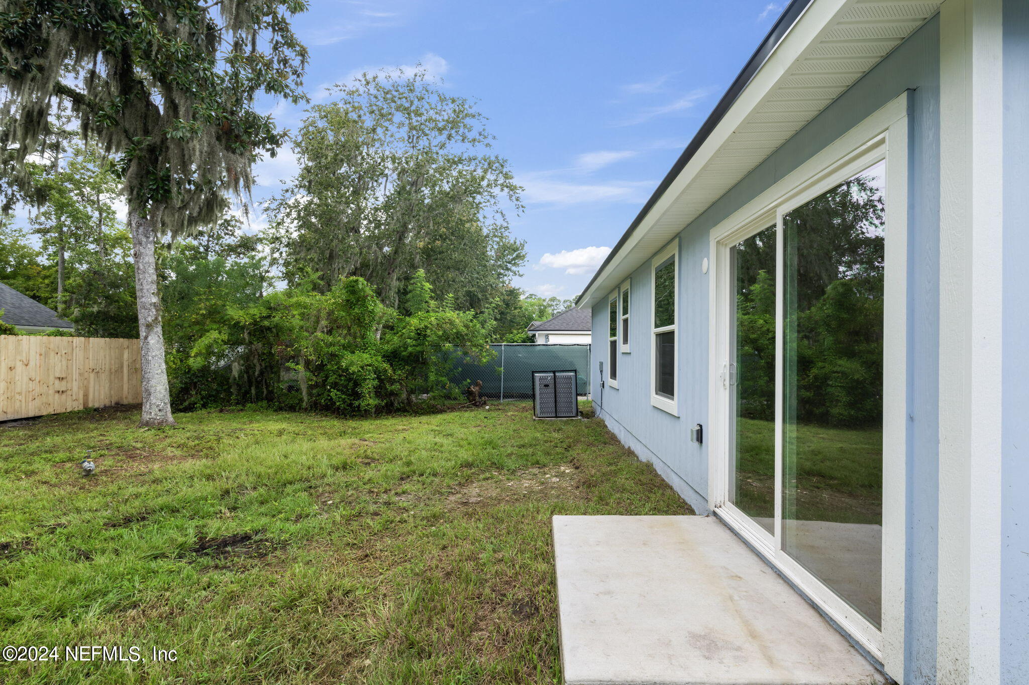 1014 Floyd Street Fleming Island, FL 32003 - Photo 32 of 48 a view of a backyard with plants and large tree