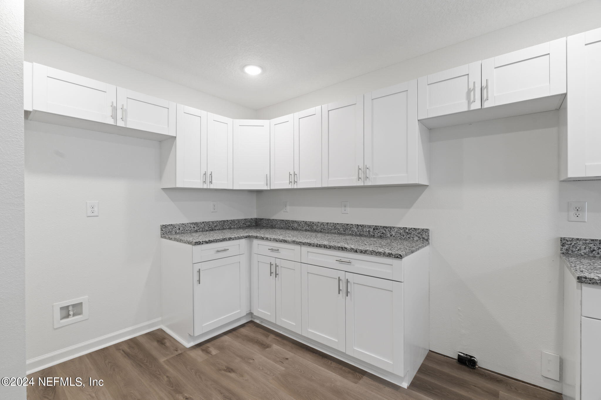 1014 Floyd Street Fleming Island, FL 32003 - Photo 10 of 48 a kitchen with a sink cabinets and wooden floor