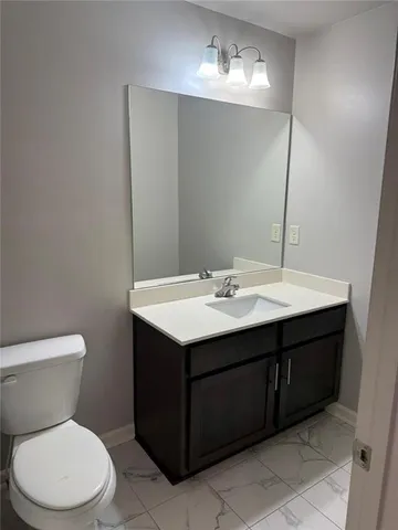 a view of a storage and utility room with wooden floor