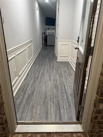 a kitchen with stainless steel appliances granite countertop a refrigerator a stove a sink a dining table and chairs