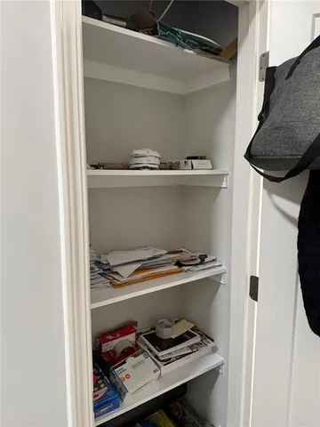 a kitchen with stainless steel appliances granite countertop a table chairs sink refrigerator and cabinets