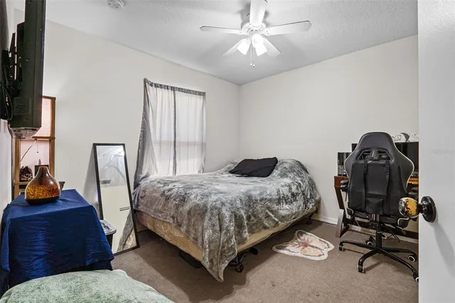 a bedroom with a bed a window and chair