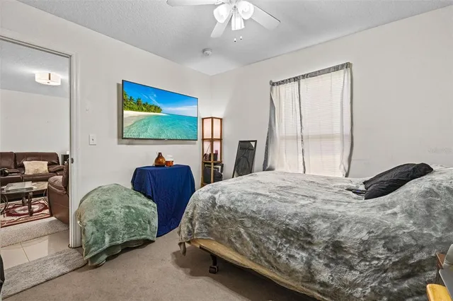 a bedroom with two beds and a chandelier