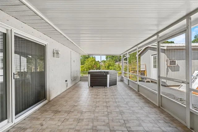 a view of a porch with furniture and a gate